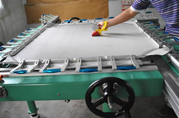 A white plastic printing mesh is tested prior to shipment. 