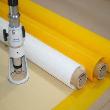 Three rolls of polyester glass printing mesh in yellow and white.