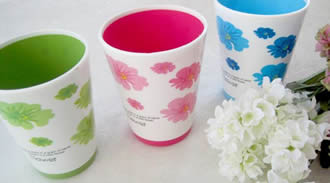 Three plastic cups are printed with similar patterns but in different colors.